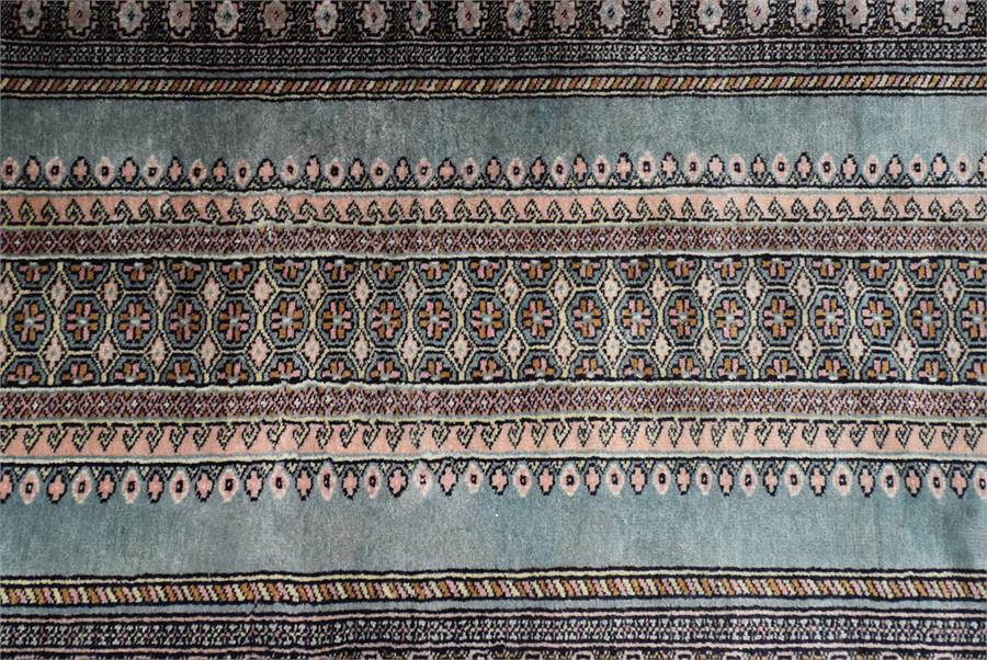 A Persian handwoven part silk runner with elongated central lozenge depicting stylised repeating - Image 2 of 2