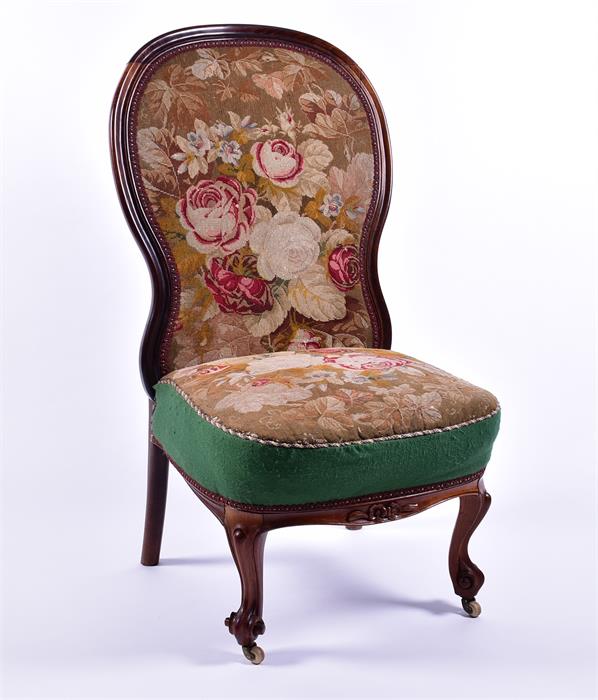 A Victorian mahogany tapestry upholstered chair on front scroll feet, 56 cm wide.