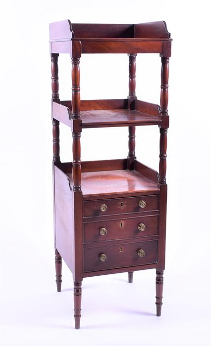 A Georgian mahogany three tier whatnot the top with low gallery, turned supports over a base with