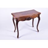 A late 19th century French walnut folding card table the serpentine top opening to reveal a baize