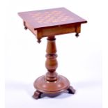 A 19th century mahogany chess top table with a single drawer and supported on a turned column to a