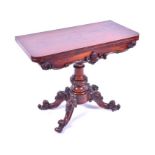 A Victorian rosewood fold over card table the top opening to reveal circular blue baize, with