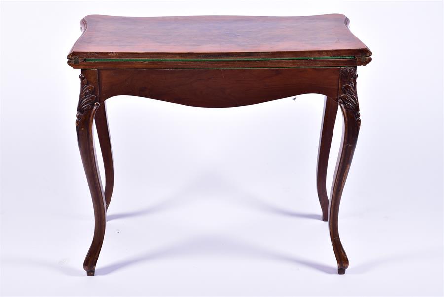 A late 19th century French walnut folding card table the serpentine top opening to reveal a baize - Image 2 of 7