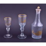 A late 18th century glass decanter with two glasses possibly Russian, of faceted form decorated with