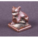 A Chinese square form bronze seal modelled as a dog raising one leg, 3.5 cm high. Provenance: