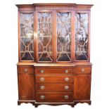 A large good quality mahogany breakfront secretaire bookcase the glazed panelled doors above a