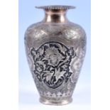 A late 19th / early 20th century Eastern white metal vase embossed with deep panels of birds,