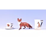 A Royal Doulton 'Reynard The Fox' trio and a Beswick fox figure the trio comprising a coffee can,