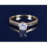 A solitaire diamond ring set with an old round-cut diamond of approximately 0.30 carats, in yellow