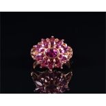 A 9ct rose gold and amethyst floral cluster ring set with oval-cut amethysts, size O 1/2, 5.2