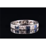 A diamond and sapphire eternity ring set with alternating old round-cut diamonds and square-cut