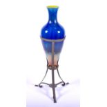 A large Bretby pottery vase on stand with an electric blue to brown glaze, and mounted in a brass