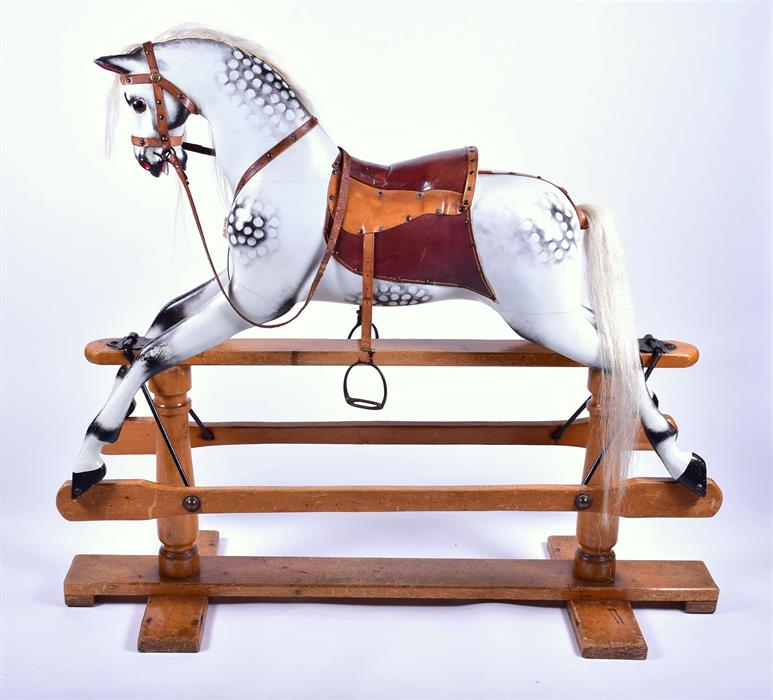 A large Victorian style painted grey rocking horse with leather harness and saddle, painted and