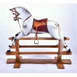 A large Victorian style painted grey rocking horse with leather harness and saddle, painted and