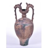 A Chinese pottery twin dragon handled amphora vase possibly Tang dynasty, with remnants of green