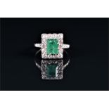 A diamond and emerald cocktail ring set with an emerald-cut emerald of approximately 1.0 carats,