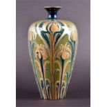 A late 19th century Florian Macintyre William Moorcroft vase of baluster form with a pinched neck