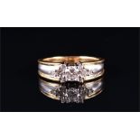 An 18ct yellow and white gold and diamond ring set with a round brilliant-cut diamond of