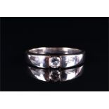 A 9ct white gold and diamond ring tension-set with a round brilliant-cut diamond of approximately