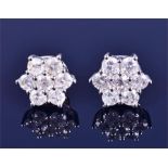 A pair of 18ct gold and diamond floral cluster ear studs each daisy cluster  with seven round