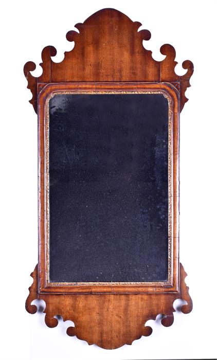 A Georgian mahogany framed pier glass wall mirror with cut scrolling frame, 88 x 44 cm (maximum).