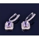 A pair of 18ct white gold, diamond, and kunzite earrings each set with a faceted rectangular-cut