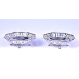 A pair of octagonal silver footed dishes with pierced decoration, bearing Birmingham hallmarks,