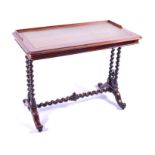 A Victorian rosewood writing table the gilt tooled leather top with gallery back, and supported on