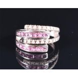 A 9ct white gold, diamond, and pink sapphire ring the split double-band ring with four terminals,