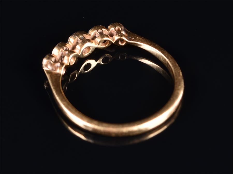 An 18ct yellow gold and diamond ring set with five graduated collet-set diamonds of approximately - Image 2 of 2