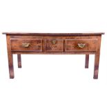 An early 18th century oak and elm dresser base the plain four plank top of good colour, over three