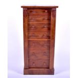 A Victorian style hardwood Wellington chest of seven drawers with turned wooden handles.