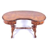 A Victorian figured walnut kidney-shaped writing desk with inset leather top over two small
