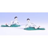 A pair of unusual Japanese nude porcelain female figures reclining on large leaves, unmarked. 16