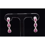 A fine pair of 18ct white gold, diamond, ruby, and morganite drop earrings set with triple cluster