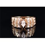 A 14ct yellow gold and diamond ring centred with a marquise-cut diamond in a raised six-claw