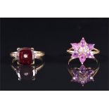 A 9ct yellow gold, diamond, and garnet ring the cushion-cut garnet inset with a small diamond,