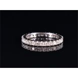 An 18ct white gold and diamond eternity ring set with round brilliant-cut diamonds, size K, 2.3