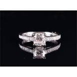 An 18ct white gold and diamond ring set with a cushion-cut diamond of approximately 0.70 carat,