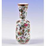A Chinese 19th century Canton enamel vase with flared neck, decorated in the famille rose palette