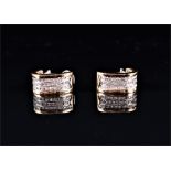 A pair of yellow metal and diamond clip earrings the clips stamped 750, 14 grams.