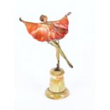 An Art Deco painted metalware figure after Lorenzl  of a dancer, mounted to an onyx circular plinth,