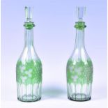 A pair of 19th century Bohemian green and clear glass decanters with engraved vineous decoration, 33