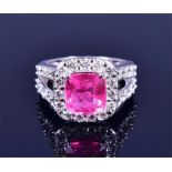 An 18ct white gold, diamond, and pink tourmaline ring set with a cushion-cut tourmaline of