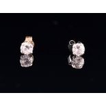 A pair of white gold and solitaire diamond ear studs the round brilliant-cut stones approximately