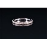 A 14ct white gold and diamond eternity ring set with round brilliant-cut diamonds, stamped 585 to