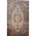 A 20th century Persian Isfahan part silk carpet the central field with a shaped diamond lozenge on a