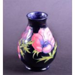 A Moorcroft vase in the Anenome pattern of squat bulbous form, with tube-lined flowers and leaves on