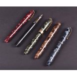 A collection of five Conway Stewart lever fill fountain pens four in marble effect cases, (one