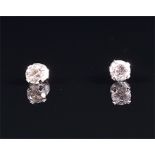 A pair of white gold and diamond ear studs each set with a brilliant-cut diamond, the stones
